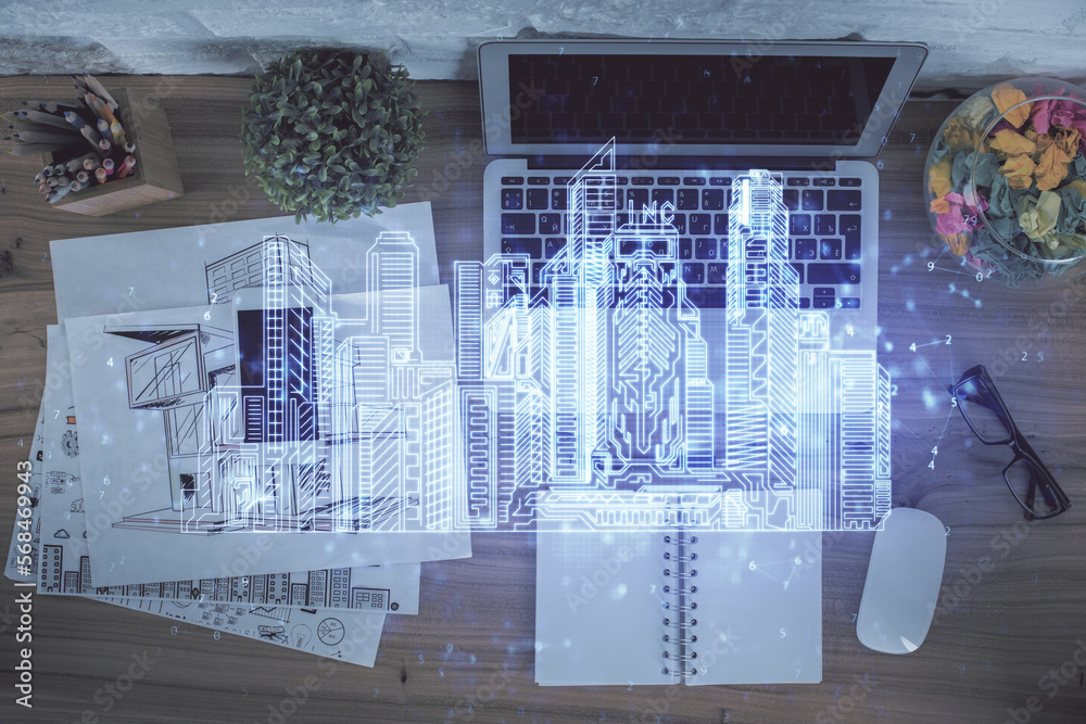 Poster city drawing over computer on the desktop background. top view. double exposure. smart home concept.