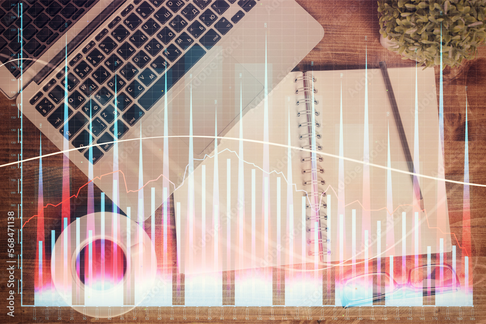 Poster financial market graph and top view computer on the desktop background. double exposure. investment 