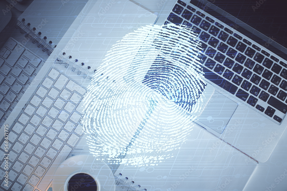 Poster finger print over computer on the desktop background. top view. double exposure. concept of securiti
