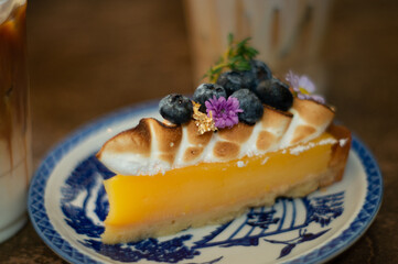 Orange cake with blueberry topping in the cafe.