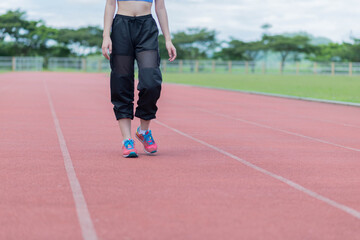 Fototapeta premium beautifull sport girl exercise at the track court and wearing blue sport bra