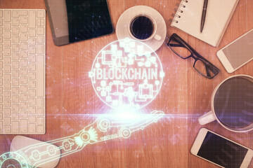 Double exposure of blockchain theme hologram over table with phone. Top view. Crypto technology concept.