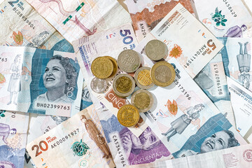 Colombian pesos coins on bills of different denominations