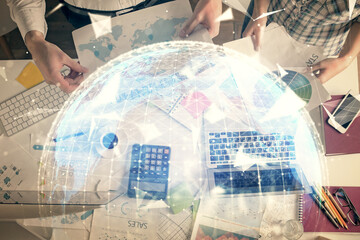 Double exposure of man and woman working together and business theme hologram drawing. Computer background. Top View.