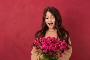 Surprised girl with a bouquet of pink roses