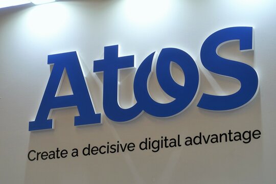 Logo du groupe informatique Atos, entreprise de services du num&eacute;rique (ESN) fran&ccedil;aise, et son slogan "Create a decisive digital advantage", sur un panneau au salon Eurosatory de juin 2022 (France)