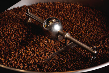 Brown coffee beans roasting process on professional roaster machines, top view