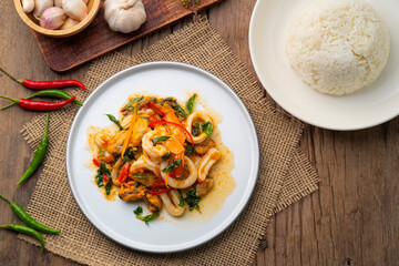 Stir-Fried Shrimp ,green Mussels and squid with thai holy Basil on white plate.Top view