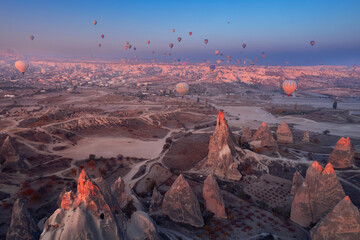 Obraz na płótnie Canvas Romantic vacation Goreme national park, color hot air balloons fly, Amazing sunrise Cappadocia. Turkey travel Concept, aerial view