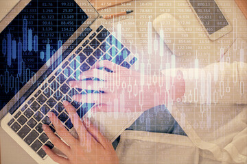 Double exposure of woman hands working on computer and forex chart hologram drawing. Top View. Financial analysis concept.