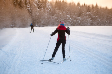 Woman cross country skiing on a sunny winter morning