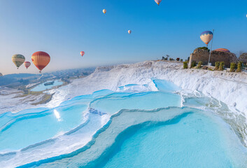 Concept Travel Pamukkale Turkey. Hot air balloon flying Travertine pool and terraces sunset