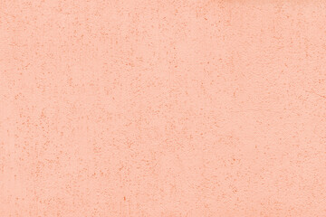 Pastel coral color old textured plaster background. Light orange rough aged exterior wall texture