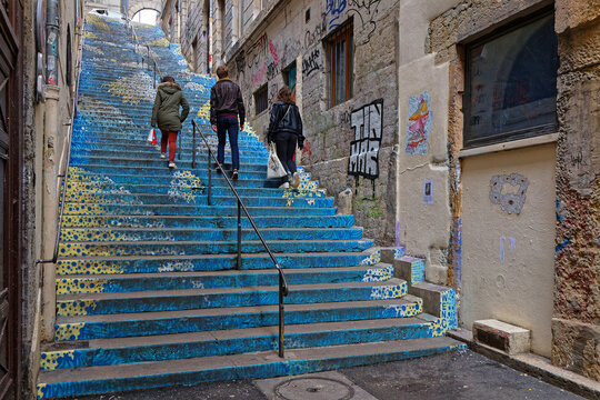 LYON, FRANCE, February 4, 2023 : Painted stairs of Passage Mermet, a famous traboule in Croix-Rousse district. Traboules are a type of passageway under houses originally used by silk manufacturers.