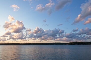 Sunset at seashore with buffy clouds in the sky in summer, Rymättylä, Finland.