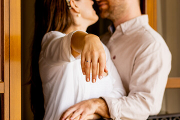 close up of wedding proposal ring on woman hand , happy couple posing and exhibition the wedding...