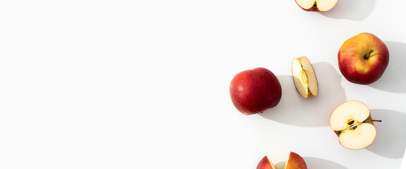 Whole, halves and cut apples on a white background. Top view, flat lay. Banner