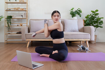 Fototapeta na wymiar Healthy asian woman practicing relaxation yoga at home. Spending time and playing at home concept