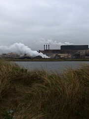 Obraz na płótnie Canvas January 2023, Dunkerque - Winter walk on the Break dam - View on an industrial site 
