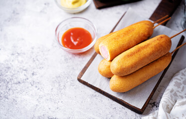 Corn dog. Asian hot dog with sauces. Street food