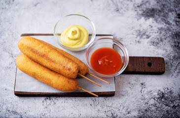 Corn dog. Asian hot dog with sauces. Street food