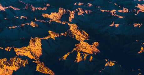 The majesty of nature on display with an aerial view of mountains basked in the last rays of the sun