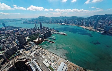 Aerial panorama of Hong Kong and  Kowloon with a city skyline of crowded skyscrapers by Victoria...