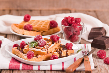 Waffles with raspberries and chocolate cream.