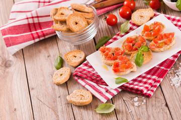 Friselle with cherry tomatoes and basil.