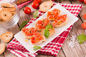 Friselle with cherry tomatoes and basil.