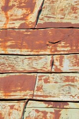 Old weathered metal roof on a building in sunny weather in summer.