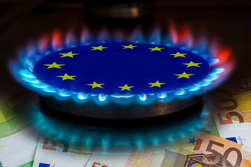 europe flag and hob burner of blue gas with euro cash banknotes on background, cost of gas, the...