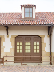 Stucco building with tile roof and window