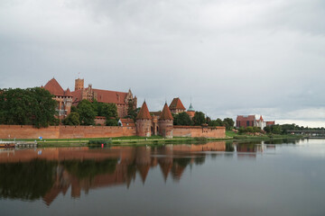 View of the main castle of the Teutonic Order in Malbork from the banks of the Vistula River. Poland.