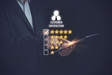 Customer review satisfaction feedback survey concept. Businessman use tablet evaluation to give a rating to customer service of five stars. Review, Ranking excellent quality customer service.