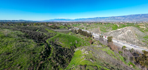 Fototapeta na wymiar A UAV Aerial view of the I-10 Freeway to Redlands and Yucaipa, California, through Reservoir Canyon with the San Bernardino Mountain Capped with Snow
