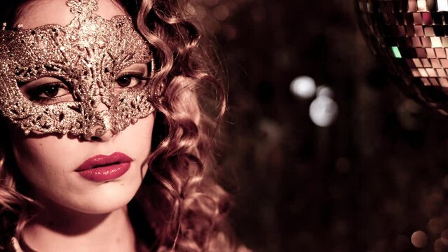 Woman with gold masquerade mask dancing 