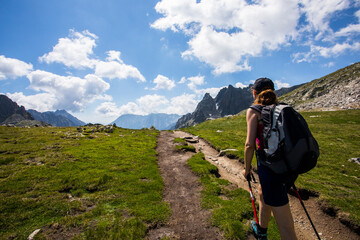 Young hiker girl summit to Ratera Peak in Aiguestortes and Sant Maurici National Park, Spain