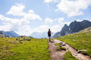Fototapeta premium Young hiker girl summit to Ratera Peak in Aiguestortes and Sant Maurici National Park, Spain