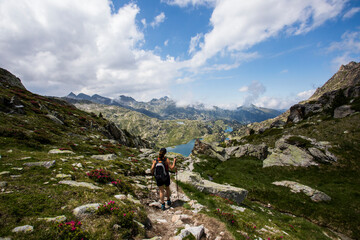 Fototapeta na wymiar Young hiker girl summit to Ratera Peak in Aiguestortes and Sant Maurici National Park, Spain