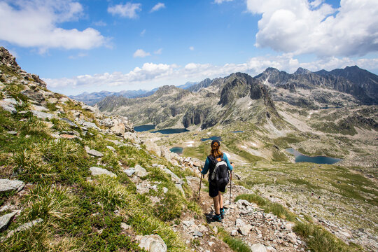 Young hiker girl summit to Ratera Peak in Aiguestortes and Sant Maurici National Park, Spain