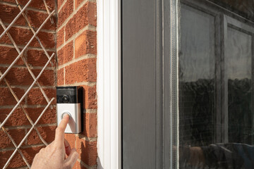 Neighbour seen pressing a popular, wireless smart door bell at the front of the house, outside the...