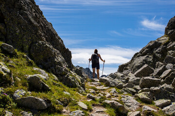 Obraz premium Young hiker girl summit to Montardo Peak in AIguestortes and Sant Maurici National Park, Spain