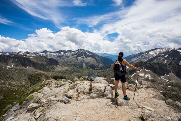 Young hiker girl summit to Montardo Peak in AIguestortes and Sant Maurici National Park, Spain