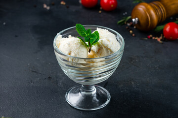 Vanilla ice cream with mint in a bowl.