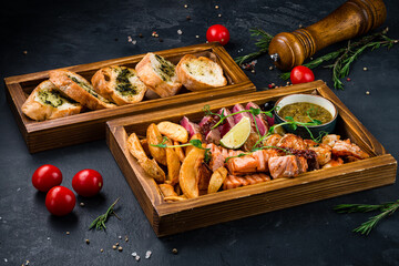 Fried shrimp with salmon, tuna, potato wedges, tkemali sauce and ciabatta.