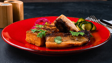 Dinner fried pork fillet with cucumbers, pickled onions and parsley.