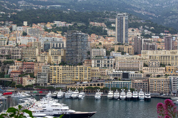 A line of yachts in front of the Monaco skyline.