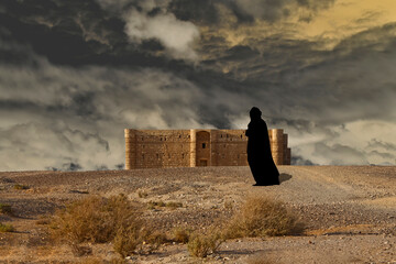 Arabic woman in the front of a castle in the desert