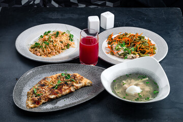 Restaurant menu pilaf with meat, stewed green beans with carrots, noodle soup, scrambled eggs with mushrooms and cranberry juice.